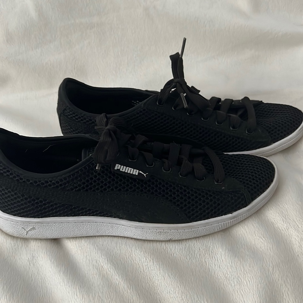 Black Puma athletic shoes